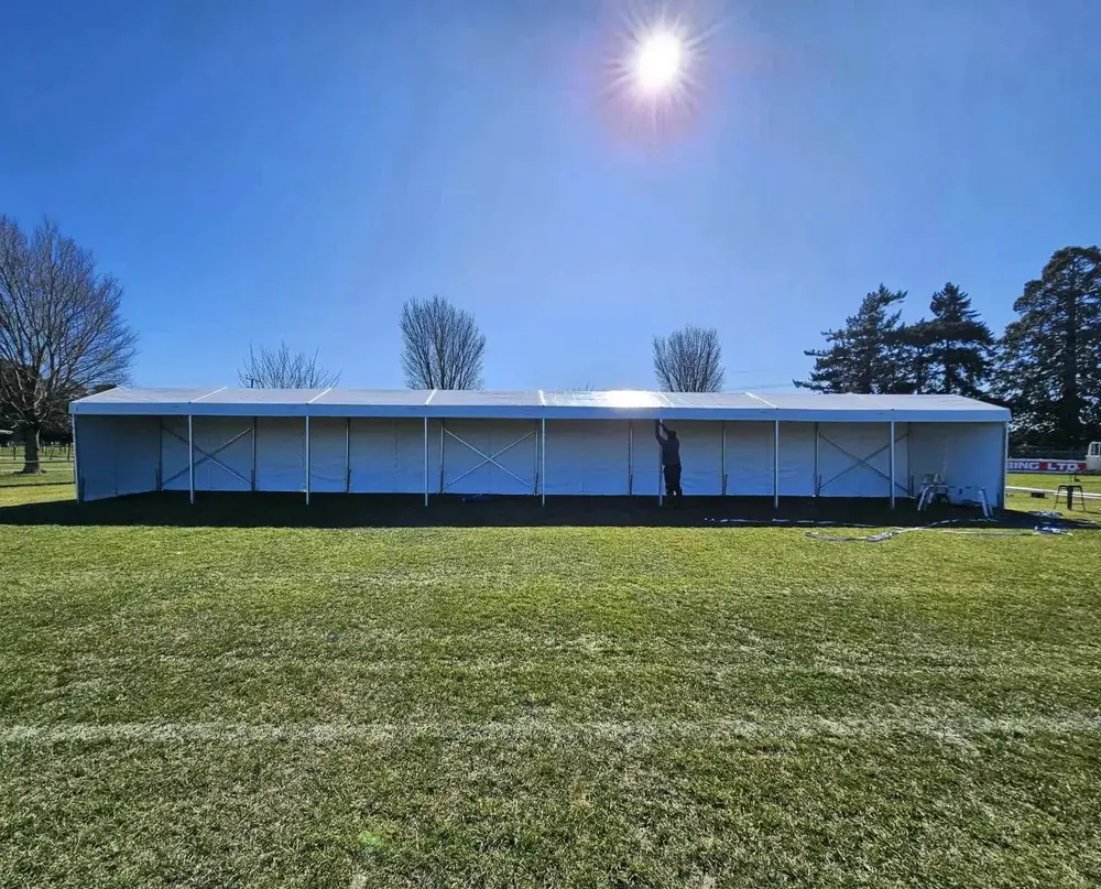 Large event marquee being installed on a sports field