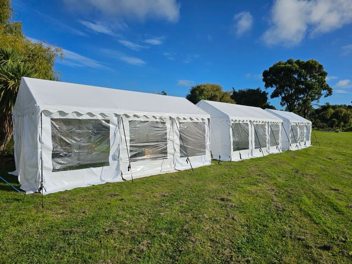 Party marquees set up on a grass field
