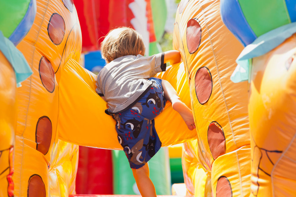 Child climbing through an inflatable obstacle course